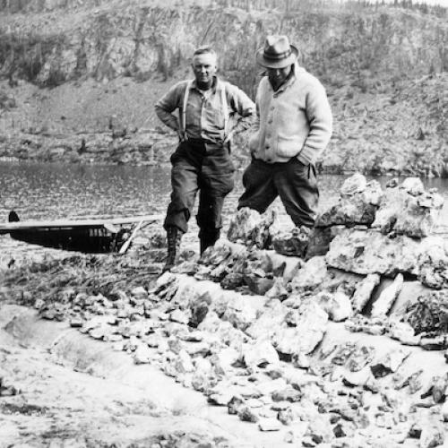 Famous prospector Gilbert Labine standing with rich pitchblende ores from Great Bear Lake. (Murdock Mosher Collection)